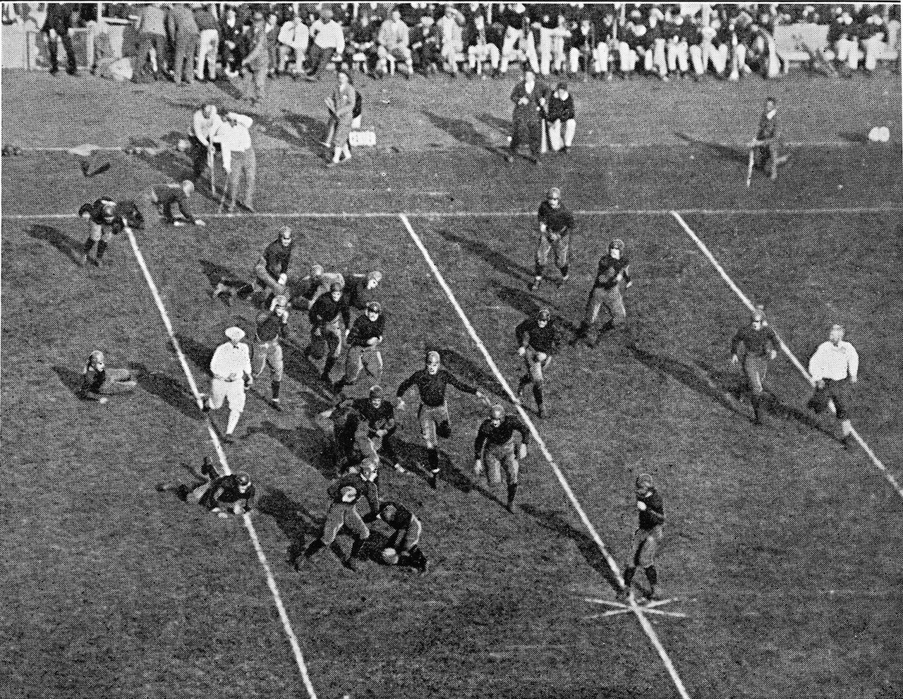 A football game in progress with the players on the field.